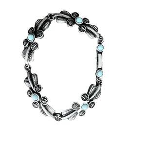 Silver and turquoise tone textured floral bracelet